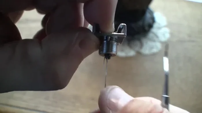 Once you have enough of the pin exposed, grasp it with needle-nose pliers and remove the rest.