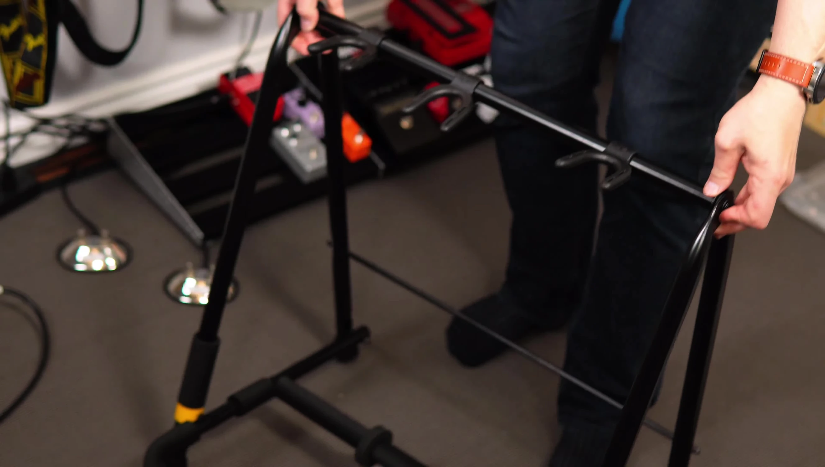 The reviewer assembling the guitar rack.