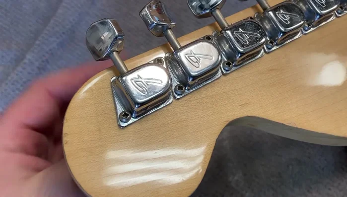 Loosen the string and remove it from the tuner post.