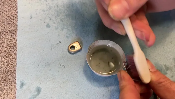 Clean the tuner cover with a toothbrush or Q-tip to remove any dried residue.