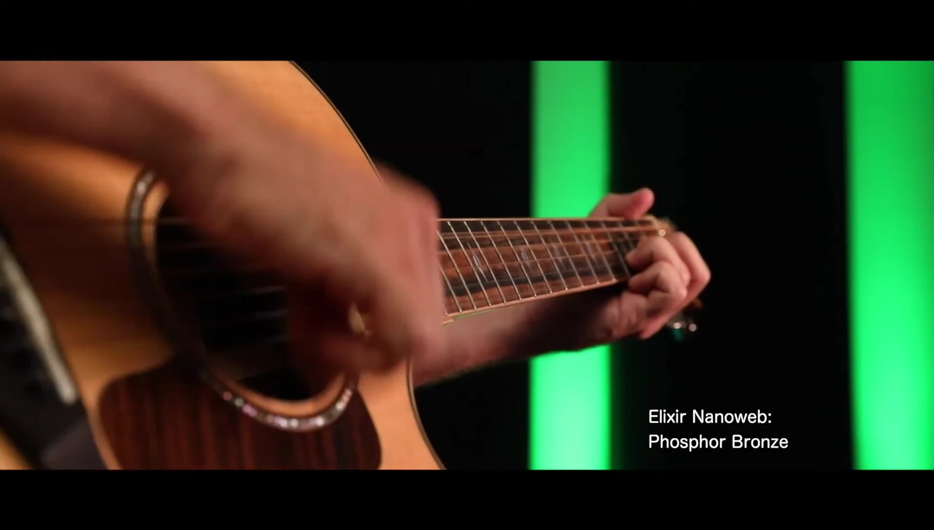 Close-up shot of the guitar with Elixir strings being fingerpicked.