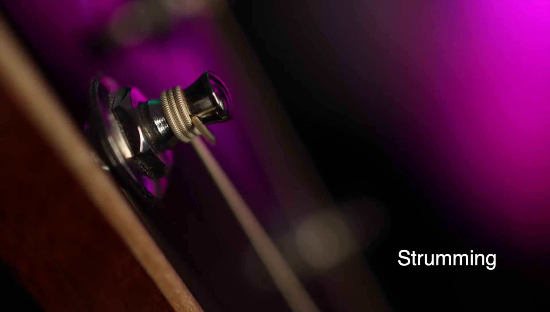 Close-up shot of the guitar with Cleartone strings being strummed.
