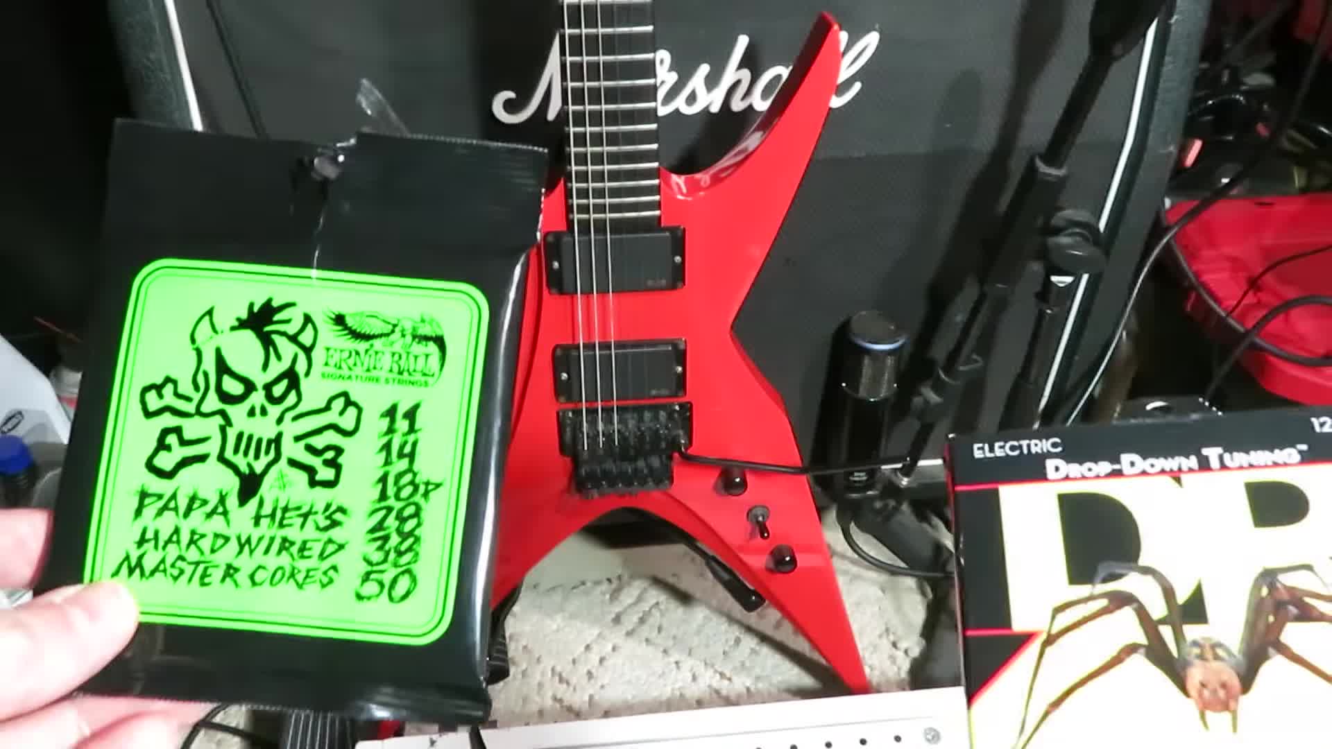 Close-up of the guitarist's hands preparing to change the guitar strings.