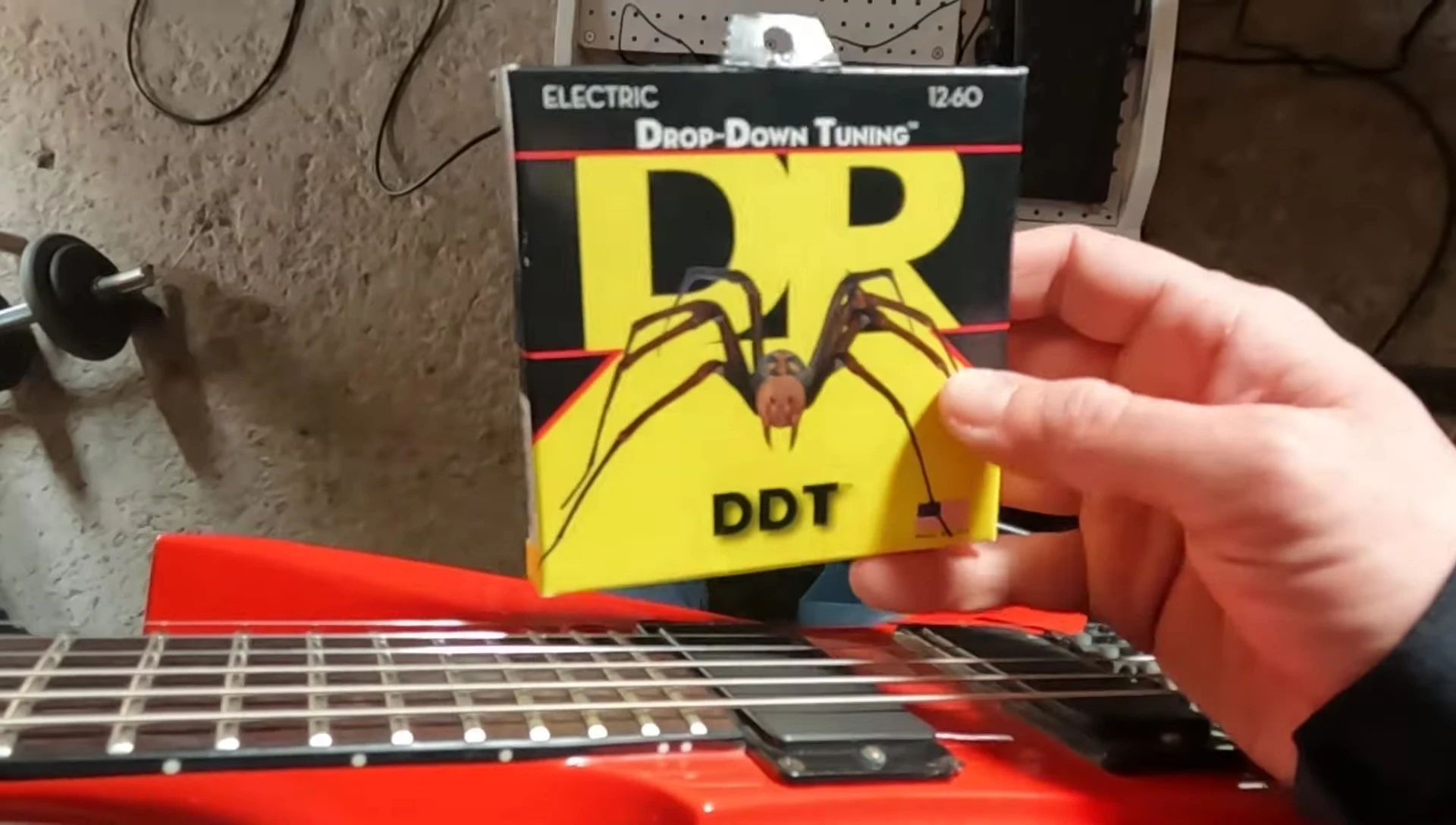 The guitarist plays in drop B tuning.