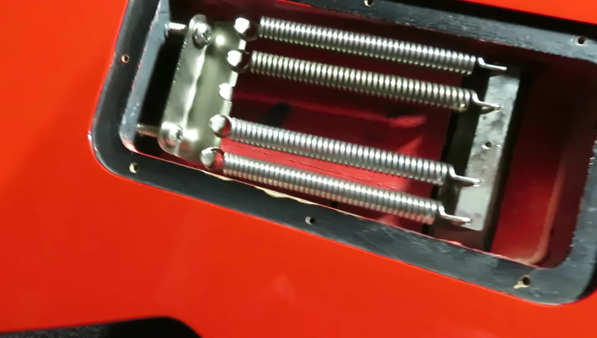 The guitarist makes additional adjustments to the bridge.