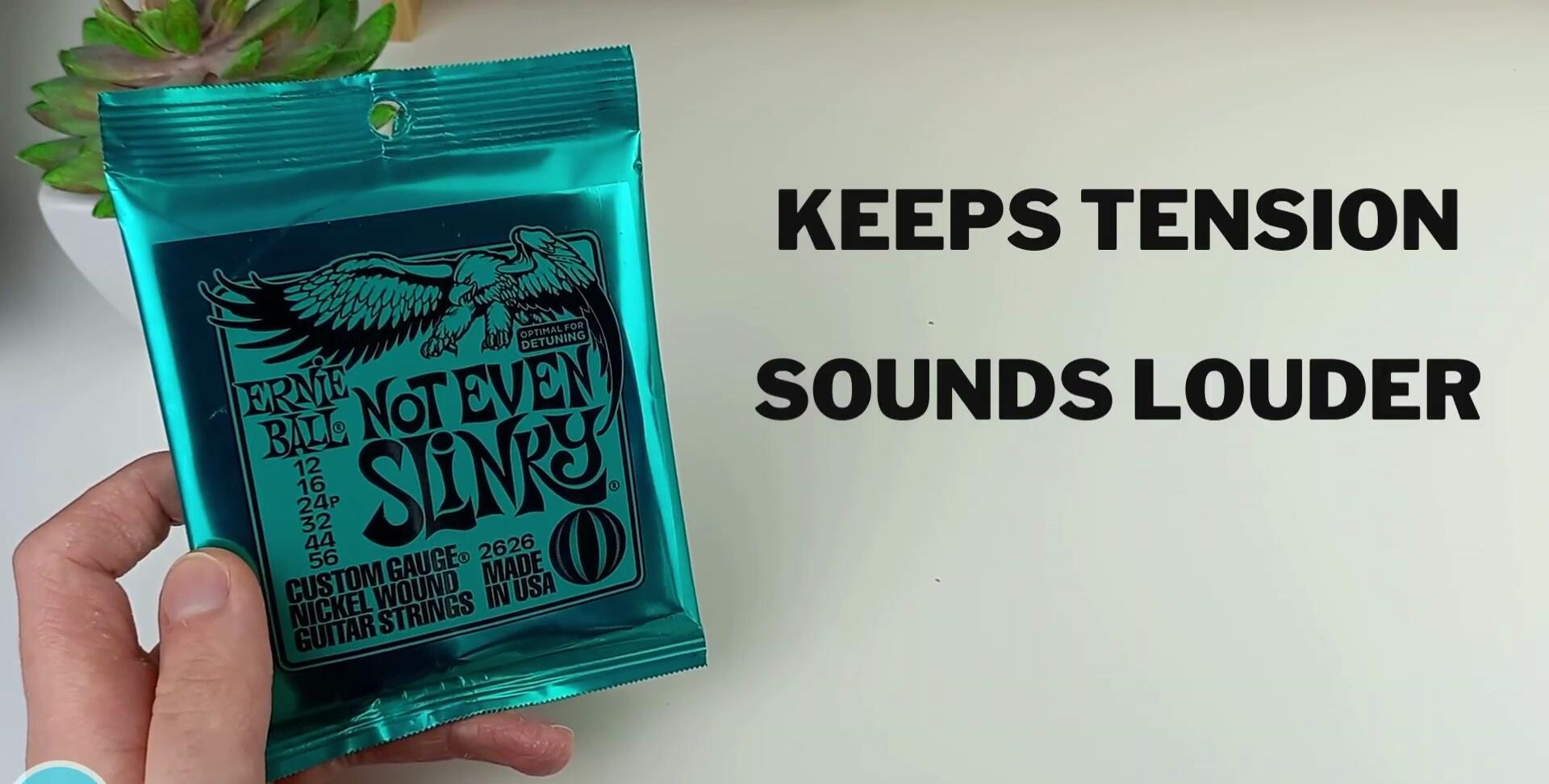 Close-up of guitar strings vibrating, emphasizing the bass.