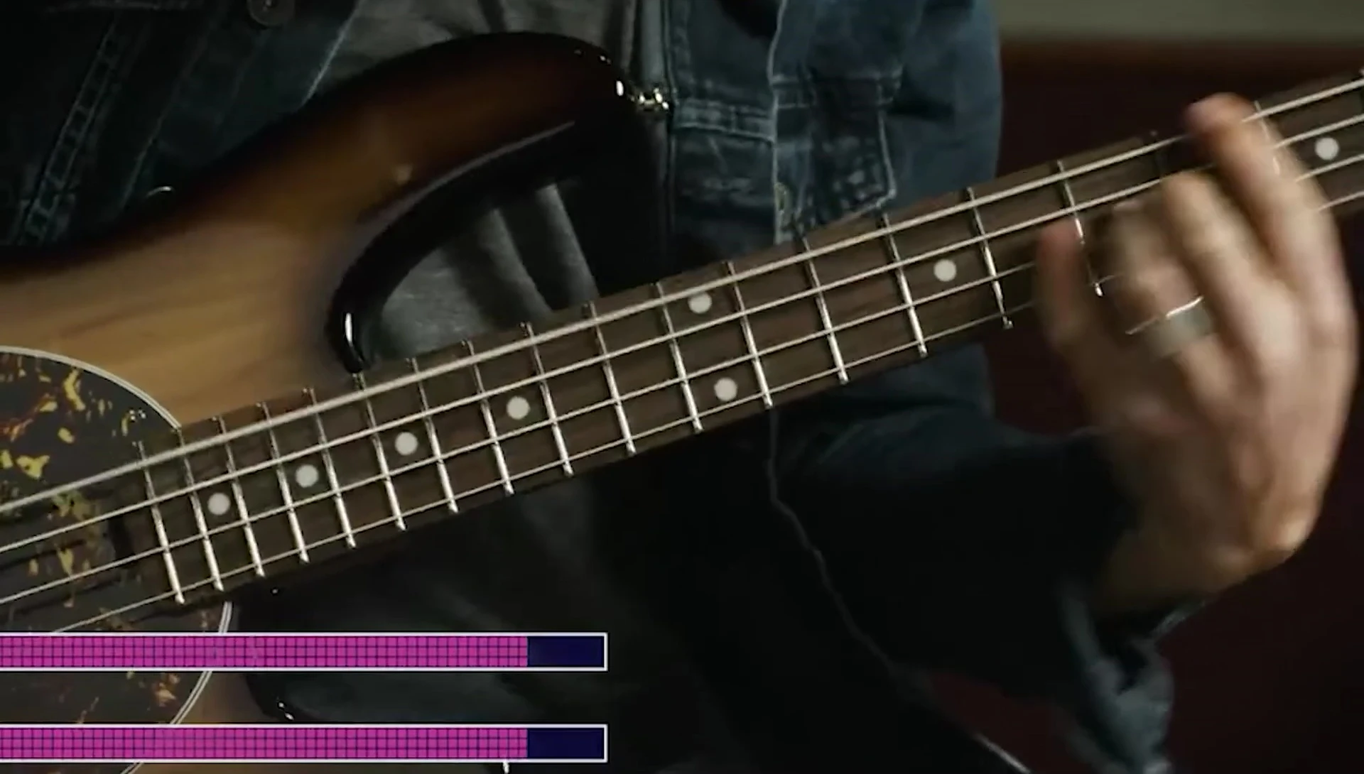 Close-up shot of Ernie Ball strings on a bass guitar