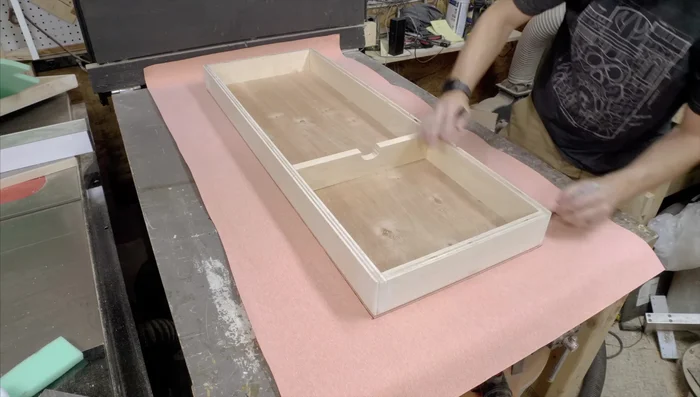 Cover the case with Tolex using spray adhesive. Apply adhesive to both surfaces, let dry, and then adhere. Work in sections for best results.