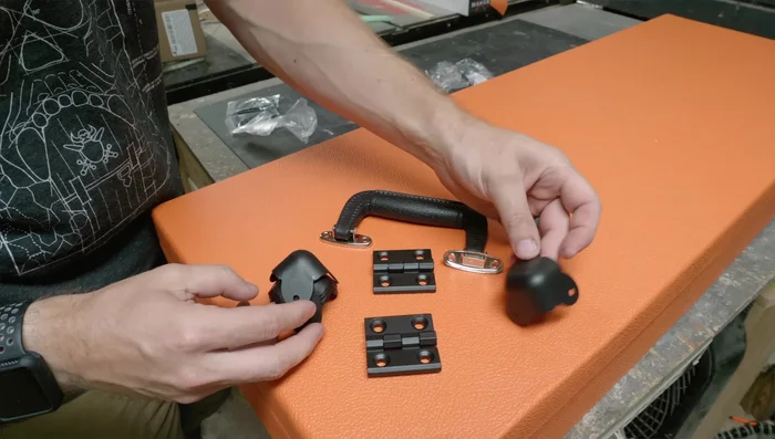 Attach hinges, corner pieces, handles, and latches.