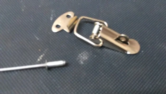 Use a square nut (or other suitable gauge) to ensure even spacing when positioning the bottom latch. Mark the positions for the bottom holes using the gauge. 