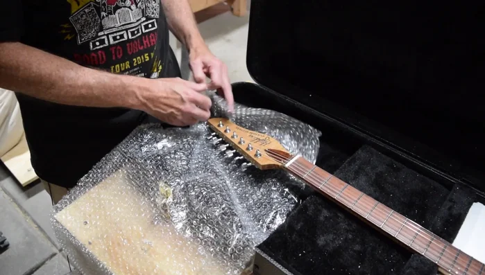 Wrap the headstock with a minimal amount of bubble wrap for cosmetic protection (avoid excessive wrapping to prevent impact transfer).