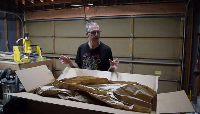 Attach the shipping label to the side of the box, maintaining the body-at-the-bottom orientation for safer transit.