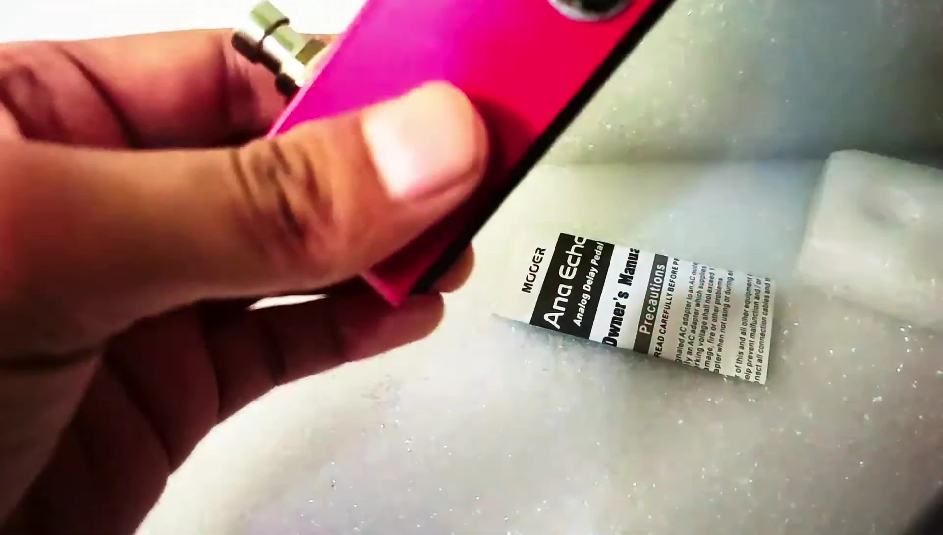 Close-up of the Mooer Ana Echo pedal box being opened