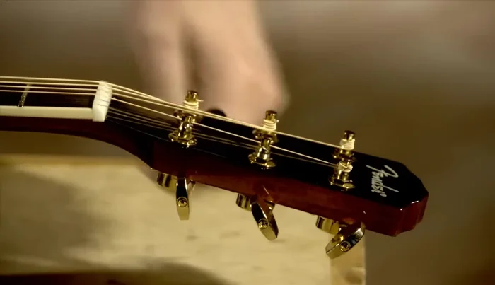 Remove the bridge pins using the string winder or your fingers (if not stuck).