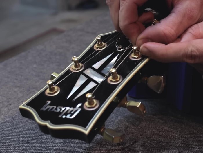 Ensure the string is seated well on the saddle and nut slot. Cut the extra string with wire clippers.