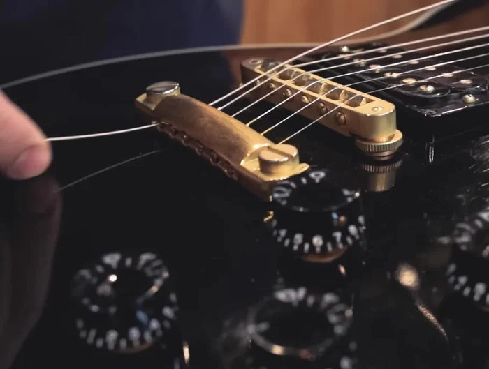 Bring the other end of the string to the headstock and feed it through the tuner hole. Avoid excessive windings around the tuners.