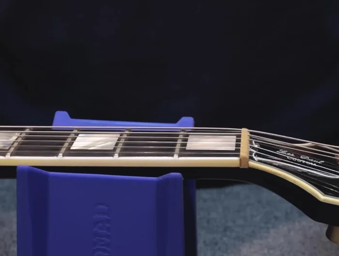 Ensure the string is seated well on the saddle and nut slot. Cut the extra string with wire clippers.