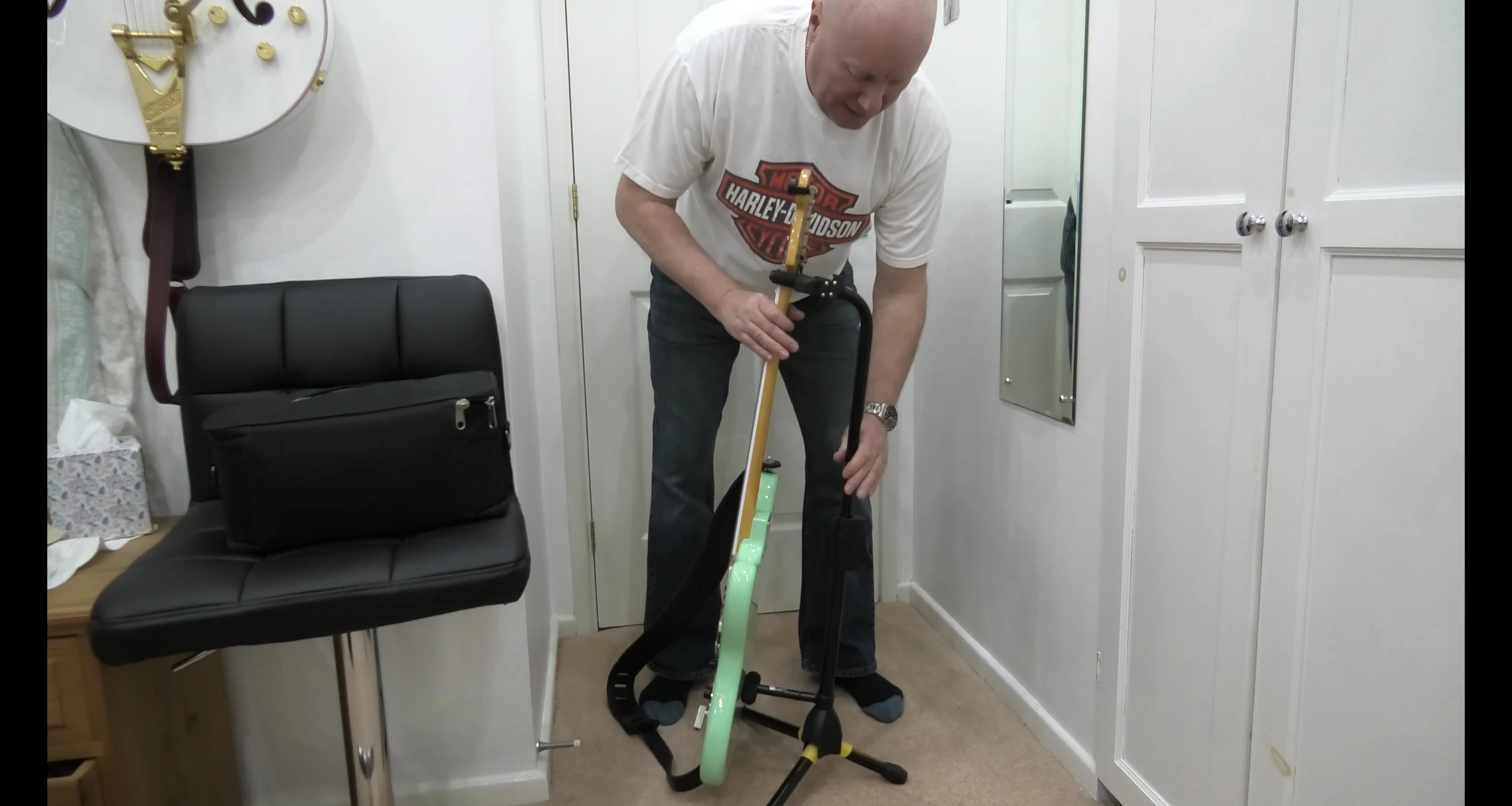 The lever mechanism for adjusting the height of the stand.