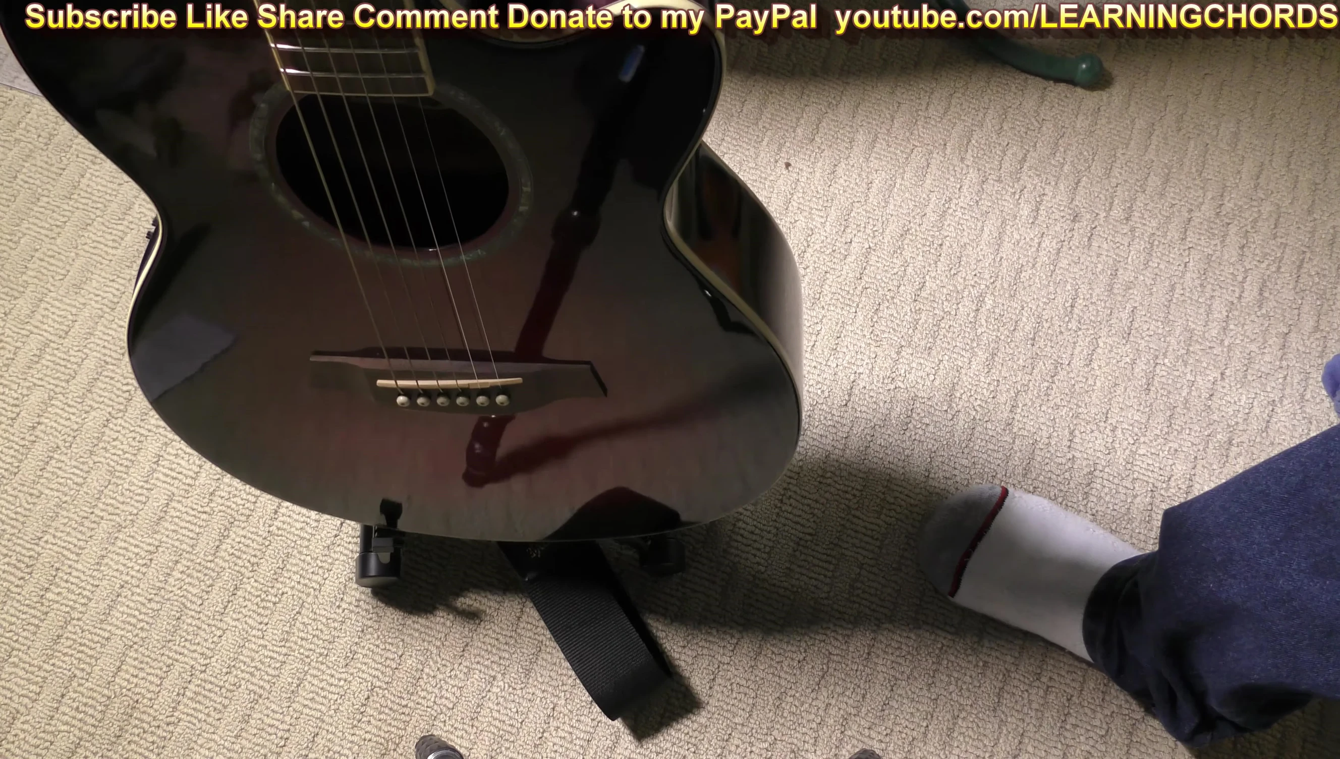 The guitar securely placed on the stand.
