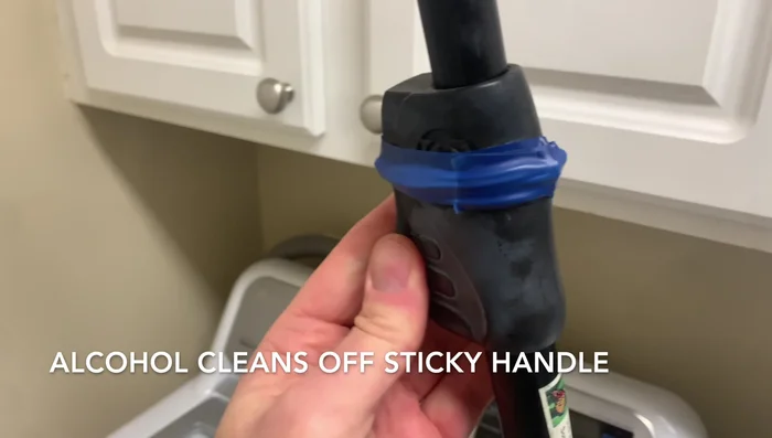 Clean the sticky residue from the plastic handle with rubbing alcohol.