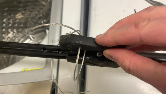 Wrap electrical tape around the wire to reinforce the knot and secure the wire in place.