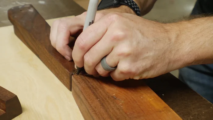 Attach the hinge using pre-drilled holes to prevent splitting.