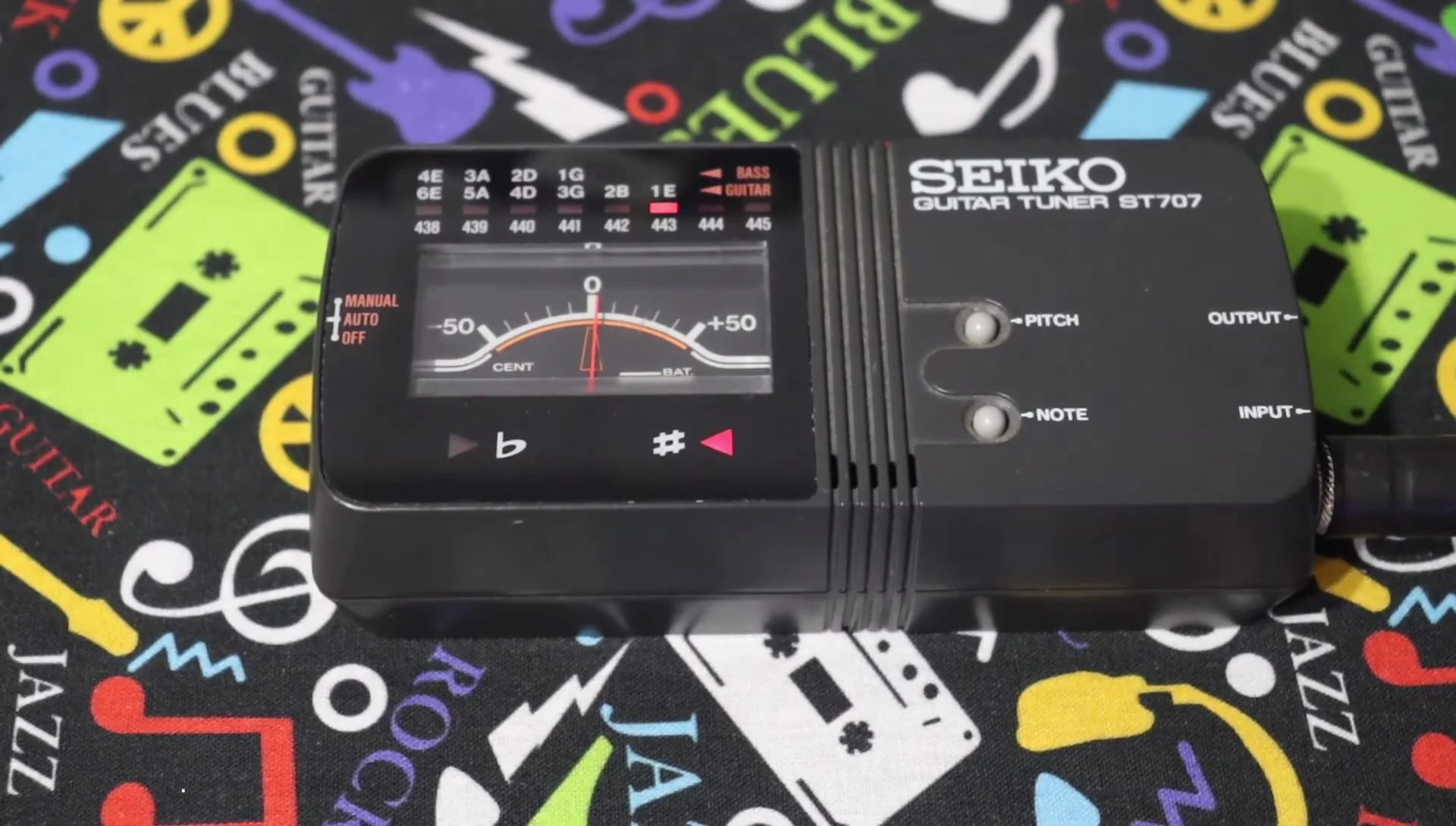 Close-up of the tuner's needle at the zero mark, showing accurate tuning