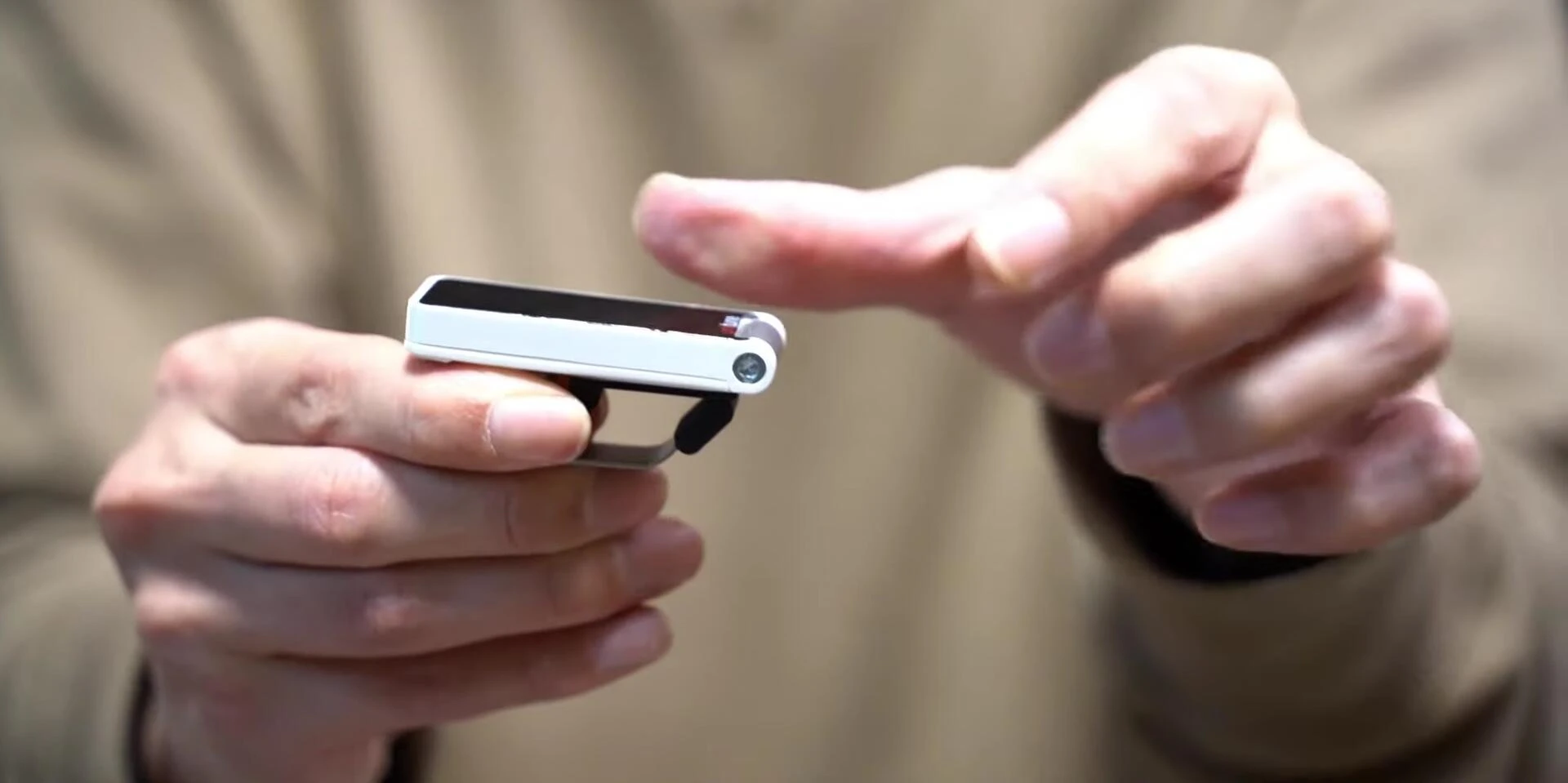 Demonstrating the flexible bending design of the TC Electronic Polytune Clip.