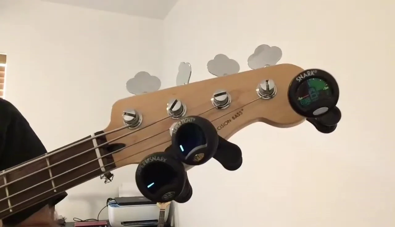 All three tuners attached to the bass guitar.