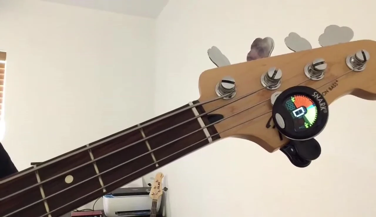 Hand activating the basic Snark tuner with a single tap.