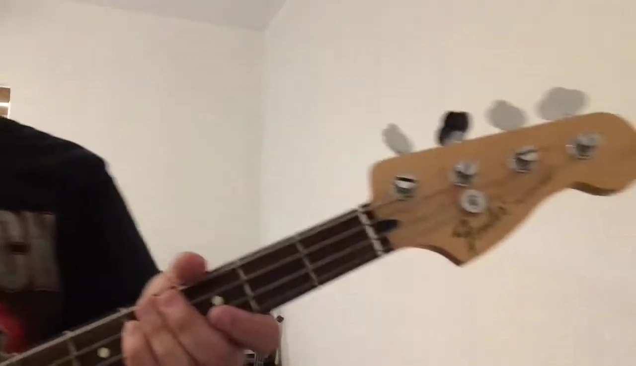 The Super Snark tuner being placed on the bass guitar in the same location as the others.