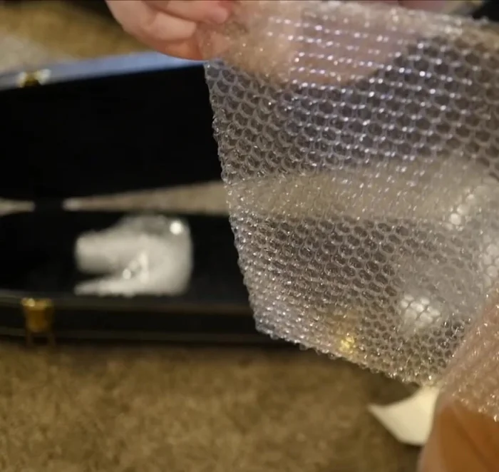 Add more bubble wrap to fill empty spaces within the case, securing the small parts.