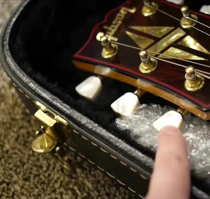 Protect the frets from pressure by placing business cards on top of them.