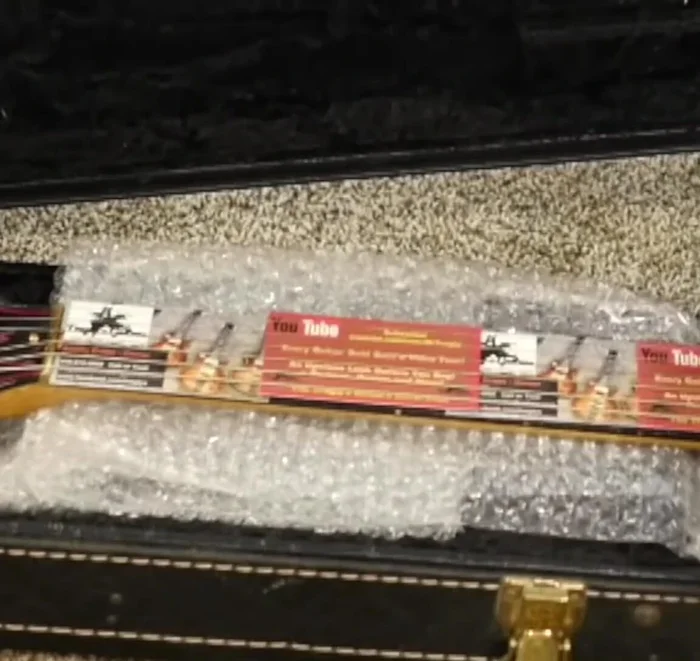 Protect the frets from pressure by placing business cards on top of them.