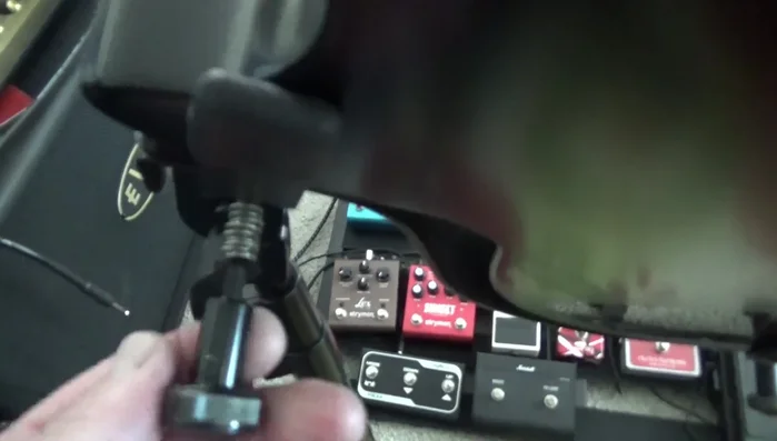 Carefully remove the collapsed spring and any associated washers, ensuring not to lose any small parts.