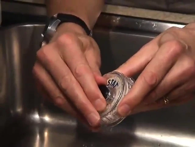 Demonstrating the removal of the filler cap.