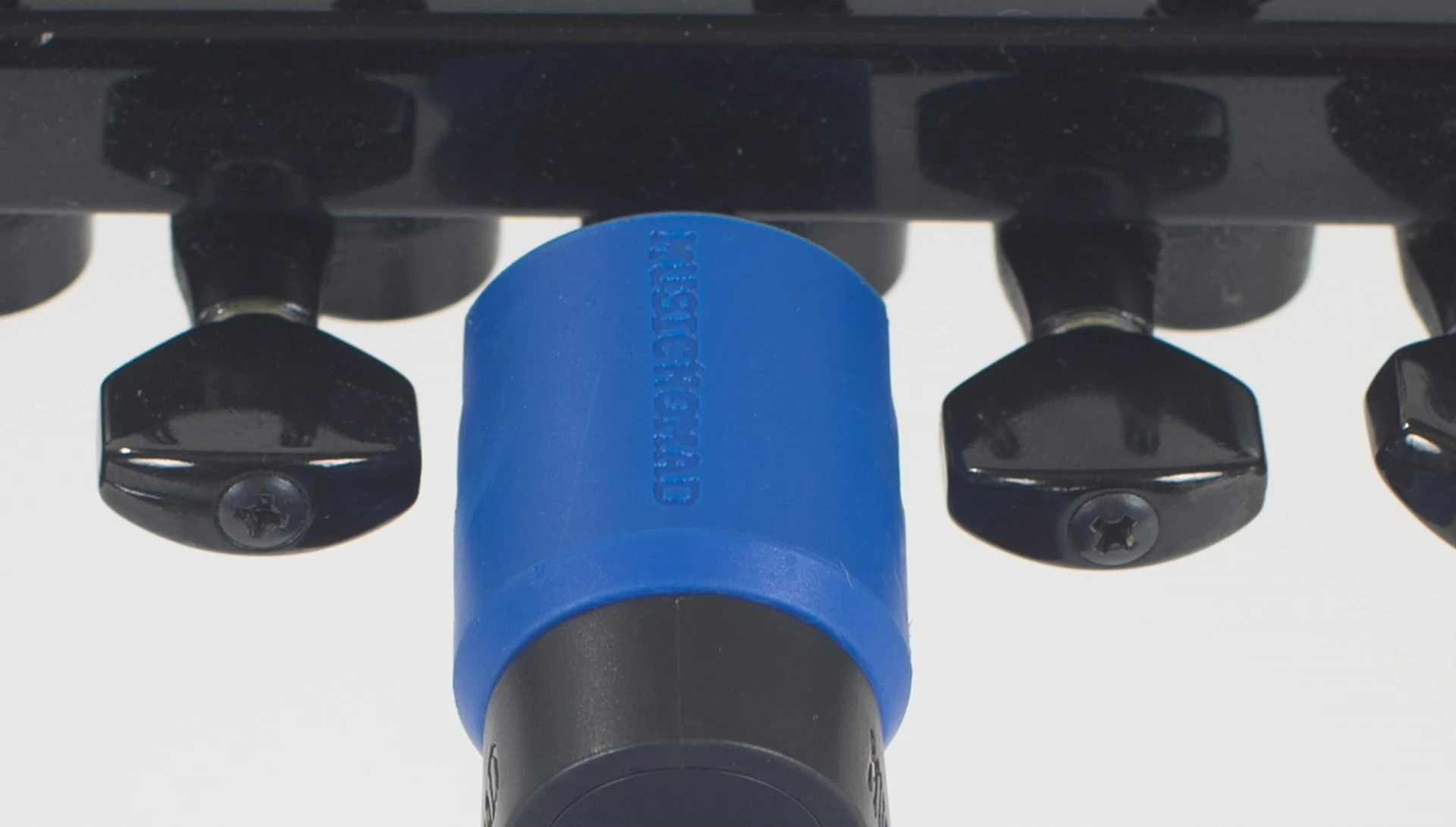 The winder in use on an electric guitar.