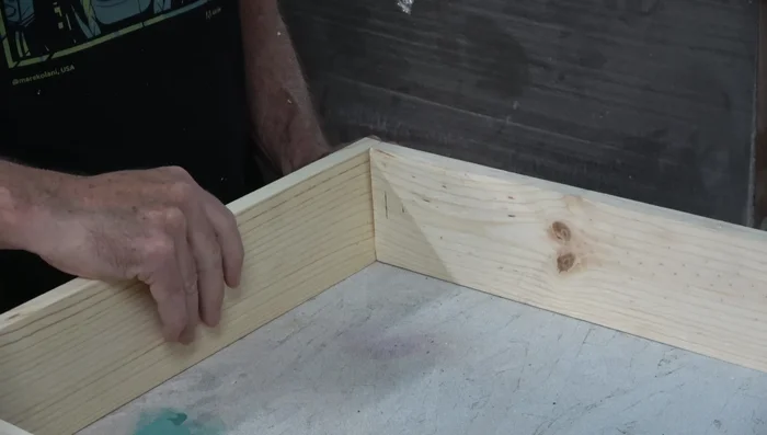 Attach top and bottom to sides with glue and brads, using weights to ensure flatness while drying.