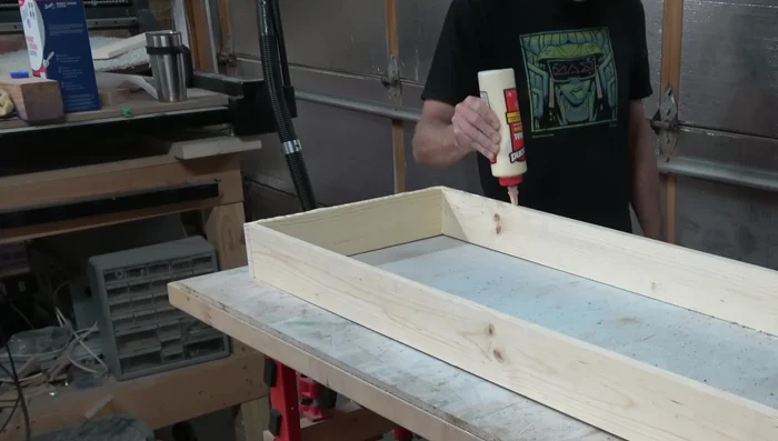 Attach top and bottom to sides with glue and brads, using weights to ensure flatness while drying.