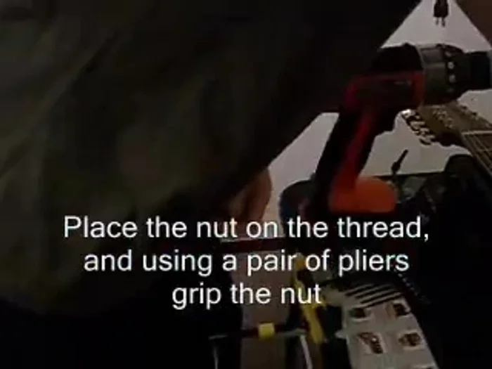 Tighten the nut using pliers, ensuring it's secure.