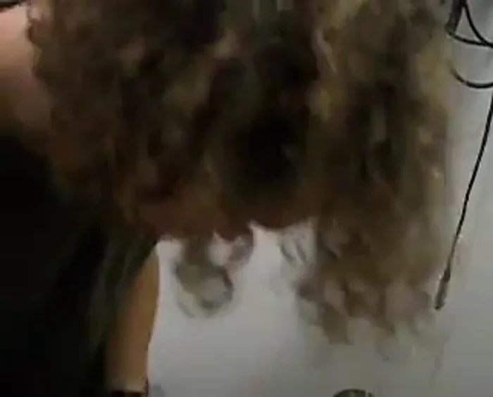 Using a 3/32 inch drill bit, drill a hole through the center of the tuner handle.