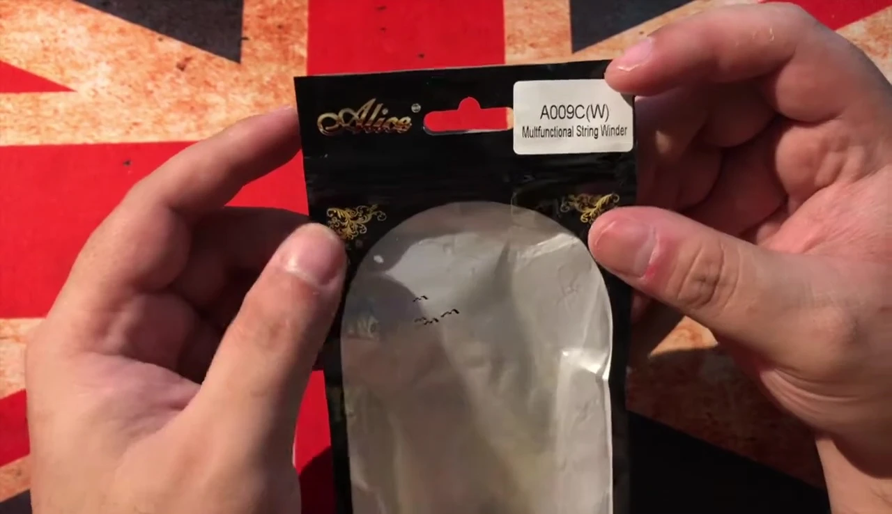 The string winder being removed from the packaging.