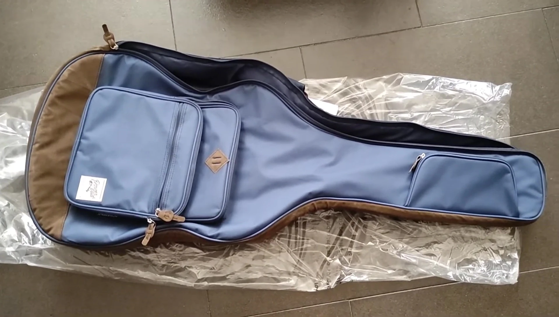 Classical guitar being placed in the gig bag