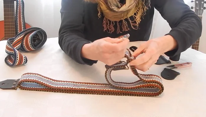 Insert the adjustment slider again (under and over the middle bar). Pull the strap through.