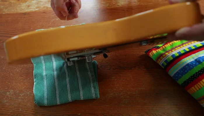 Feed new strings through the body and out the front.