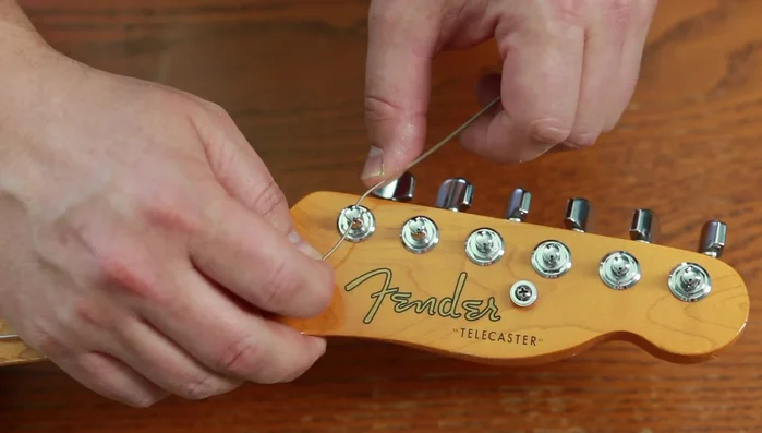 Bend string around post, tuck under, and pull tight.