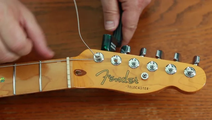 Tune string to pitch.