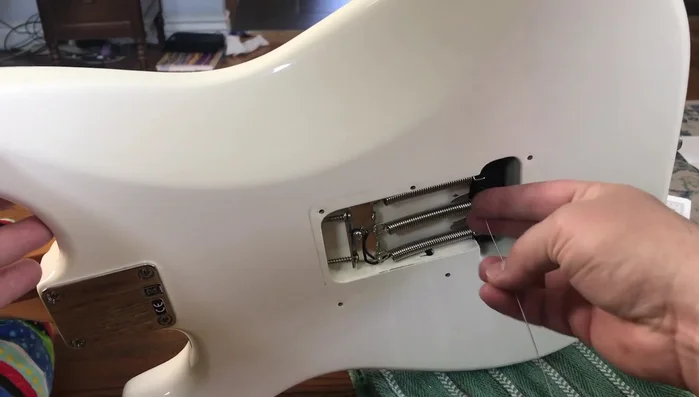 Insert string through locking tuner, tighten the lock, and turn.