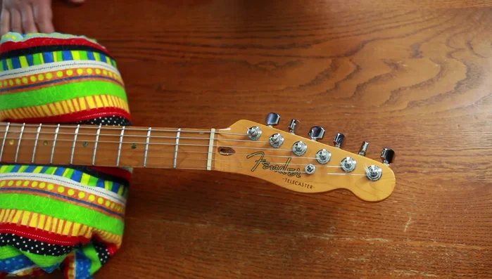 Remove old strings from tuning pegs.