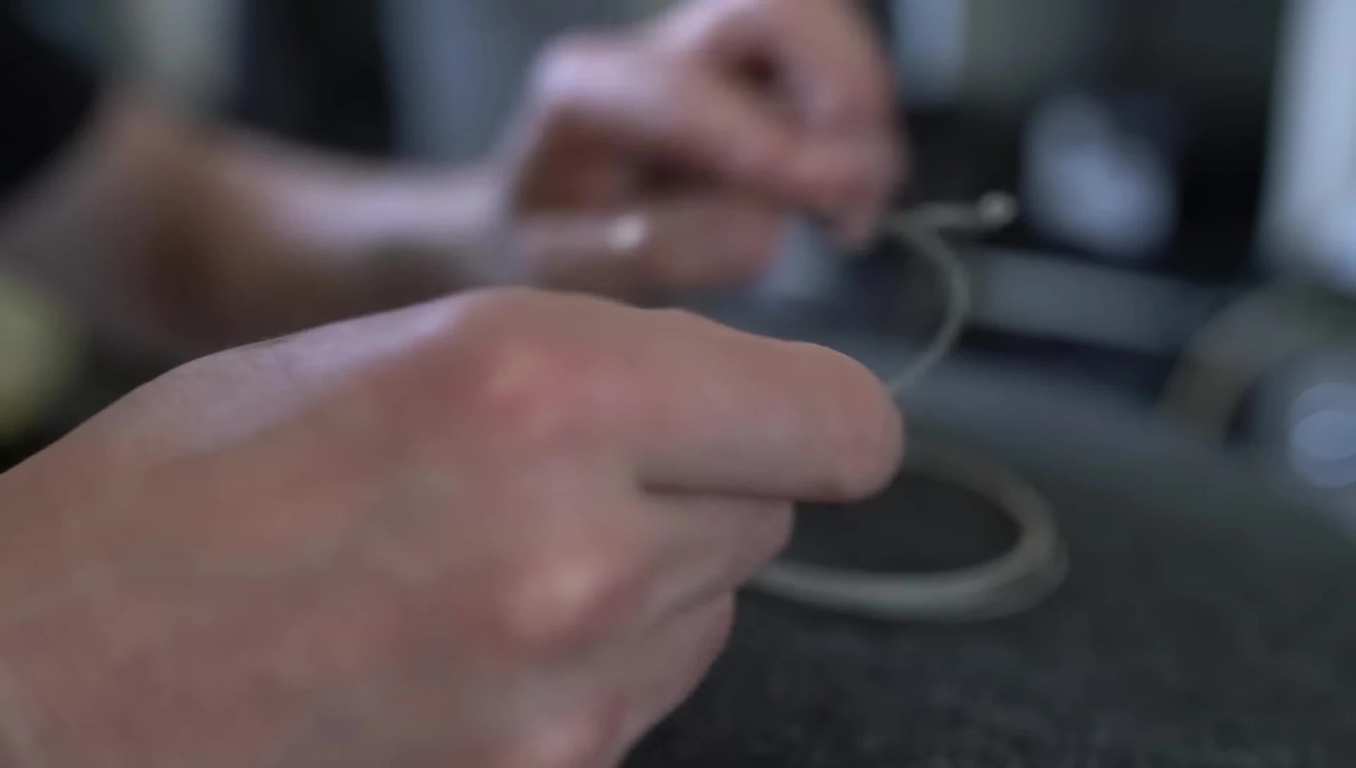 Close-up of the D'Addario XS strings being examined.
